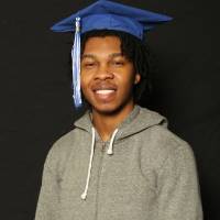 portrait style photo of man in graduation cap